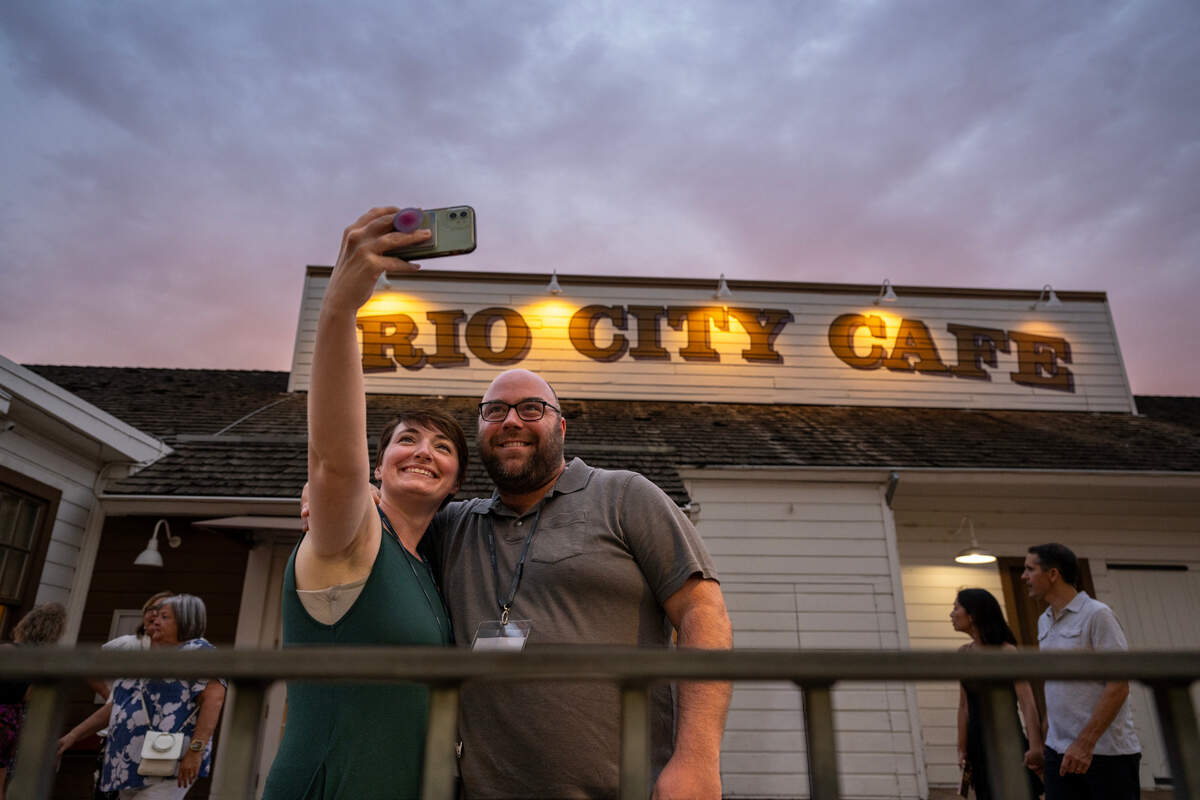 Ryan and Adrienne Newcomer, visiting from St. Louis, Mo., pose for a photograph outside the Rio City Cafe in Old Sacramento in 2024. After nearly two years, the city has yet to find an operator willing to fix up the structure.